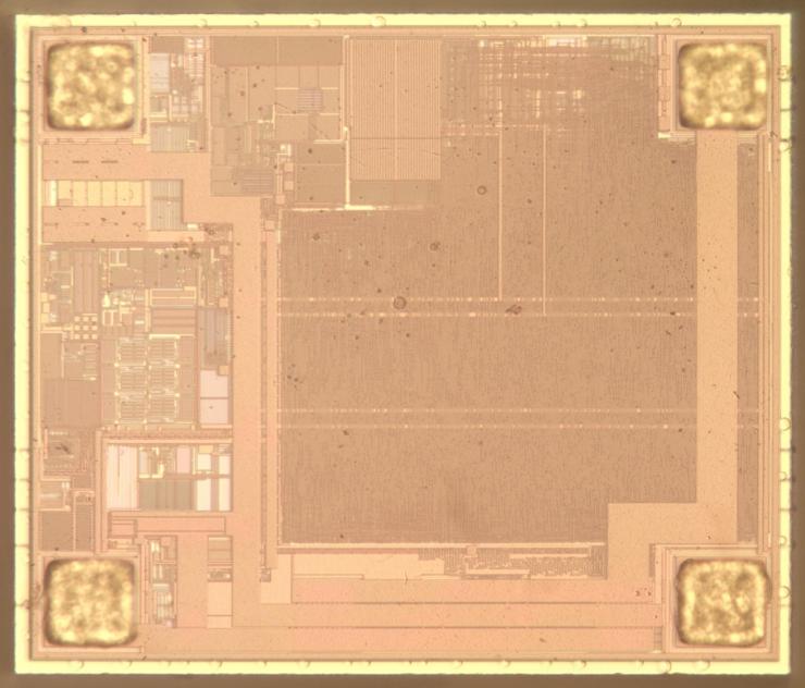 Die photo of a chip, showing various patterns on the chip's surface. This photo shows the top metal layer, consisting of thick and very thin wiring.